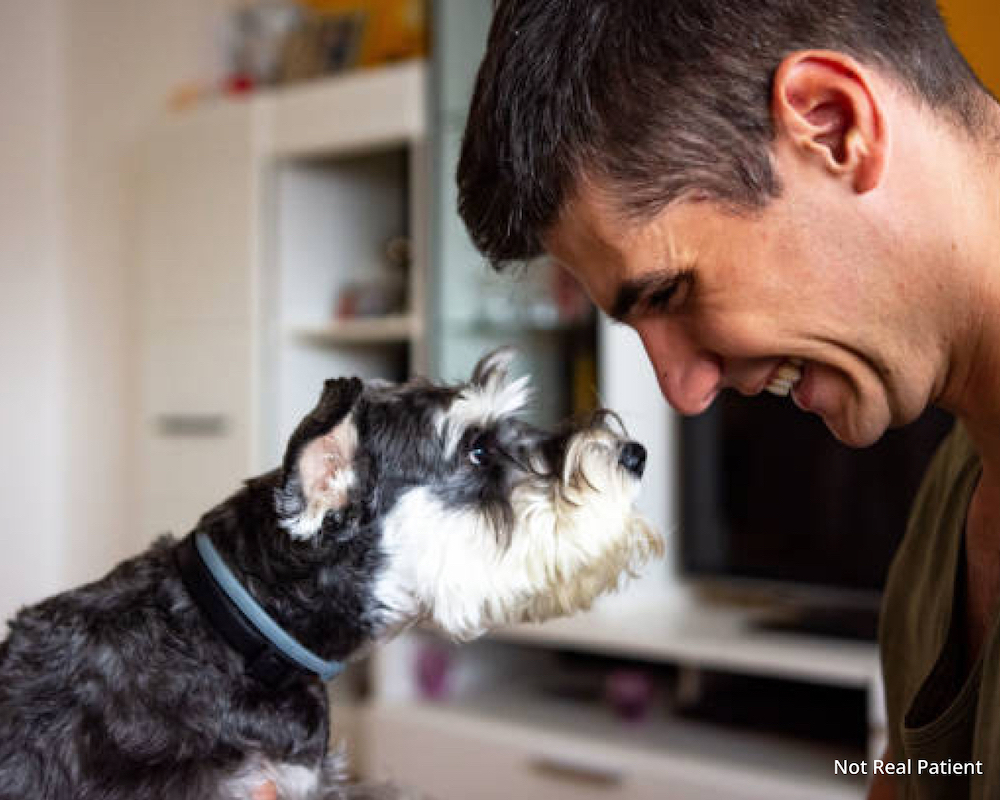 Man staring into the eyes of his dog